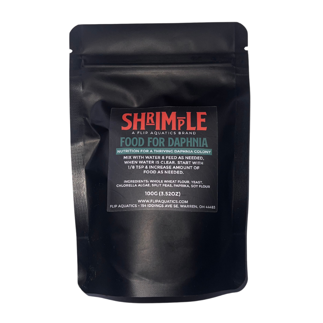 Black packaging of Shrimple food for daphnia with a label on a white background